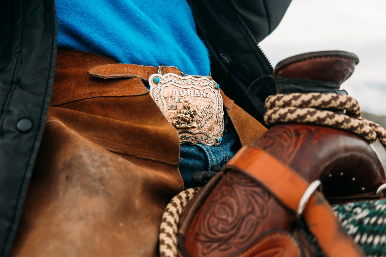 Western saddles in the tack room